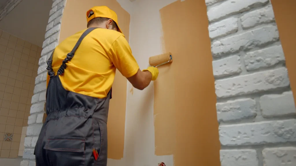 worker-painting-wall-with-paint-roller